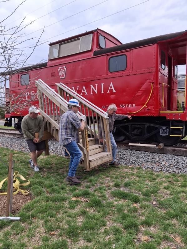 Volunteers had to first move the wooden stairs from the side of the caboose.